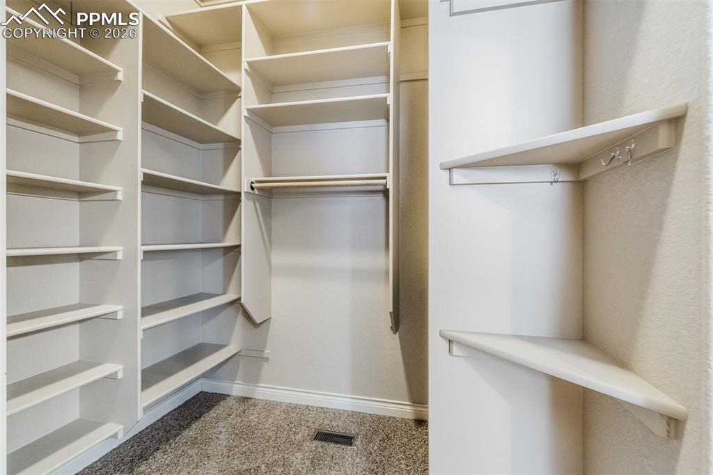 Image 19 of 38: Custom shelving in master closet