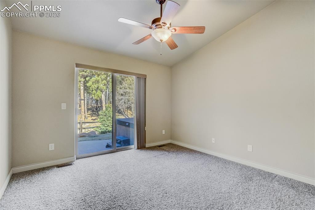 Image 20 of 38: Bedroom #2 on main level with walkout