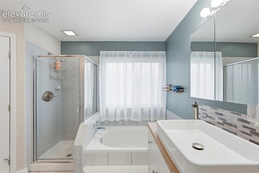 Image 33 of 50: 22" sink with dual faucets, garden tub and standalone shower