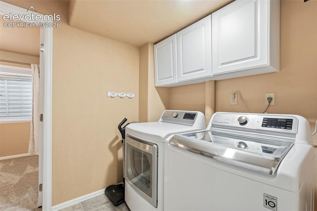 Image 47 of 50: Large Laundry room with refrigerator and microwave