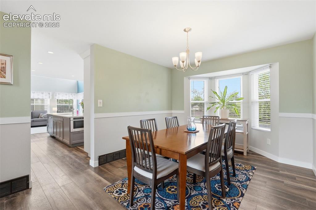 Image 9 of 50: Bright dining room with bay window