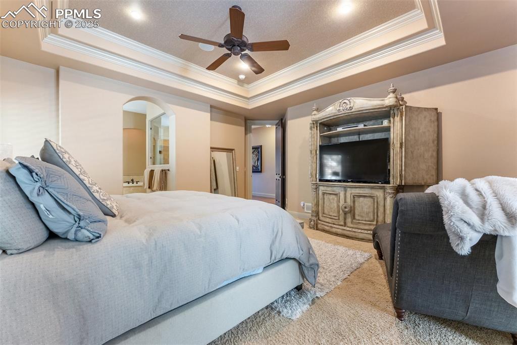 Image 18 of 50: Primary bedroom with an adjoining bathroom