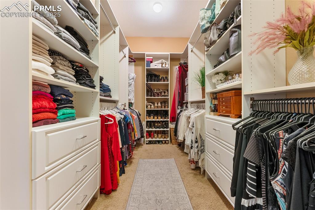 Image 25 of 50: Great walk-in closet with shelves and drawers