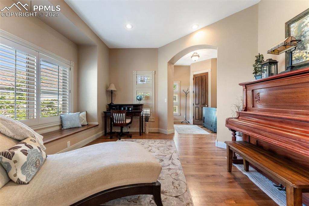 Image 4 of 50: Front sitting room with window seat and plantain shutters