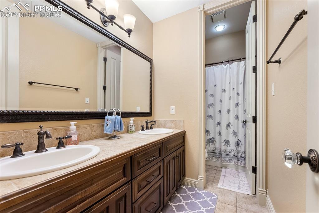 Image 42 of 50: Fifth full bathroom and with dual sinks