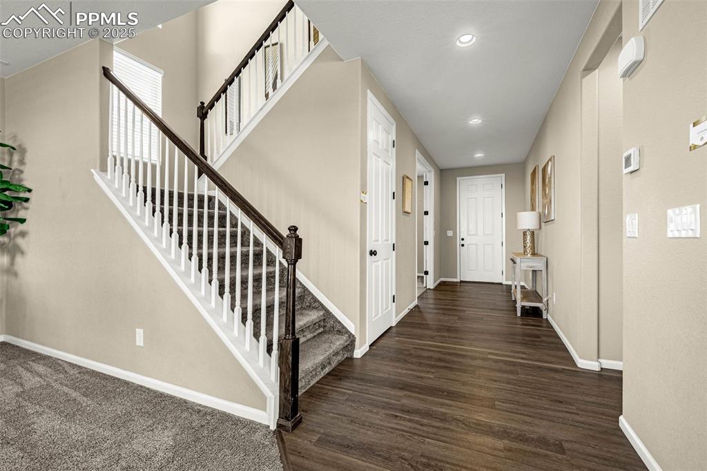 Image 11 of 42: Entryway with stairs, recessed lighting, and dark wood-type flooring