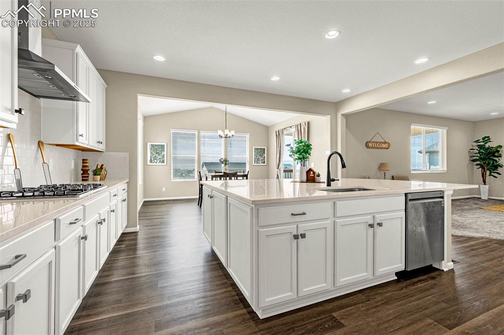 Image 14 of 42: Kitchen featuring white cabinets, plenty of natural light, tasteful backspl