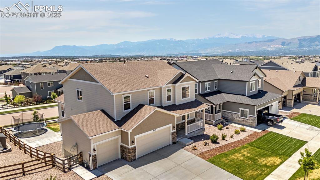 Image 2 of 42: Aerial perspective of suburban area with a mountain backdrop