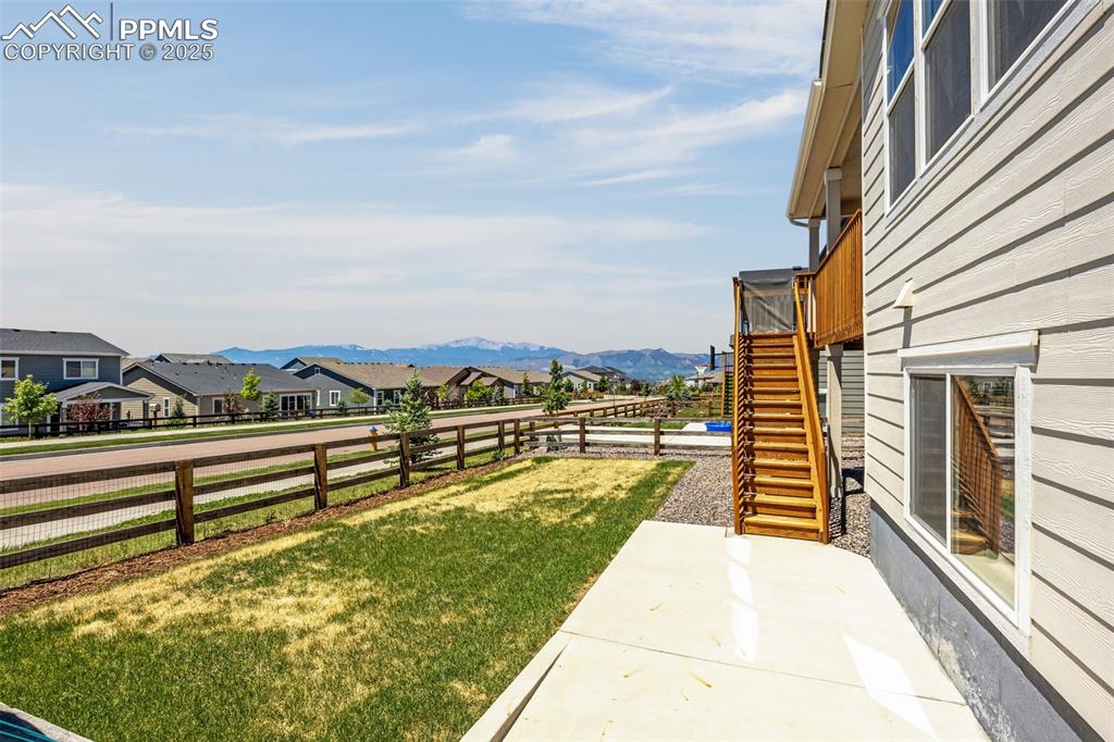 Image 34 of 42: Fenced backyard featuring a residential view, a patio area, stairs, and a m