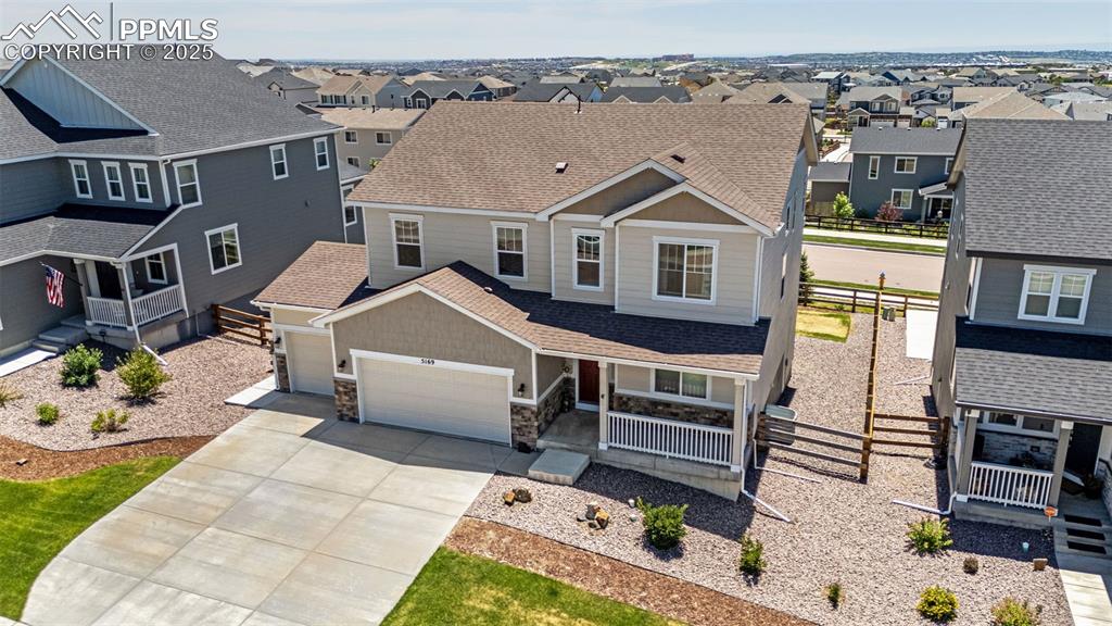 Image 35 of 42: Craftsman-style house with a residential view, a garage, concrete driveway,