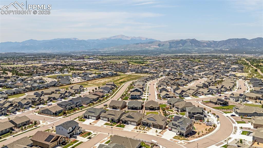 Image 42 of 42: Aerial view of residential area featuring a mountain backdrop