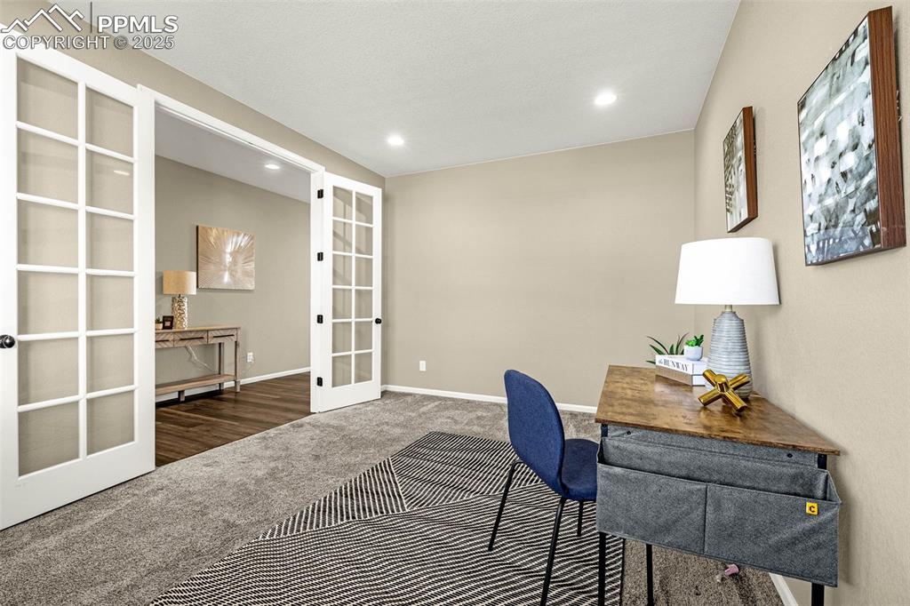 Image 8 of 42: Carpeted home office featuring french doors and recessed lighting