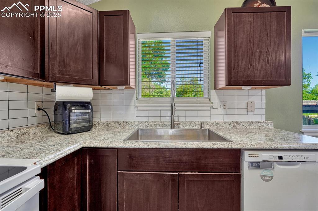 Image 14 of 47: Totally updated kitchen including cabinets, counter, floor, backsplash, and