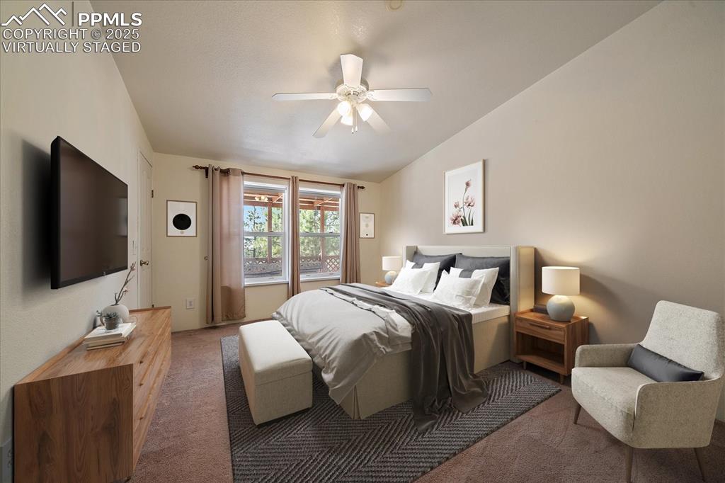 Image 22 of 50: Virtually staged bedroom, ceiling fan, and lofted ceiling