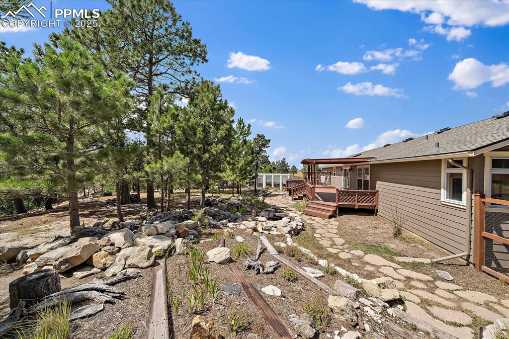 Image 36 of 50: View of yard with a deck
