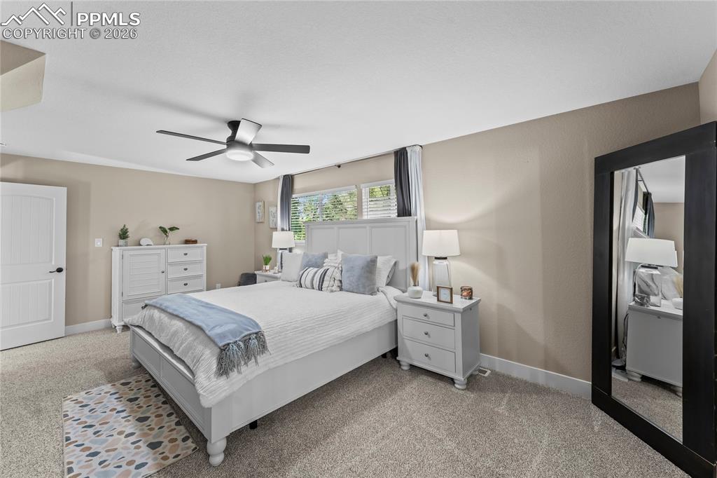 Image 14 of 44: Bedroom featuring light carpet and ceiling fan