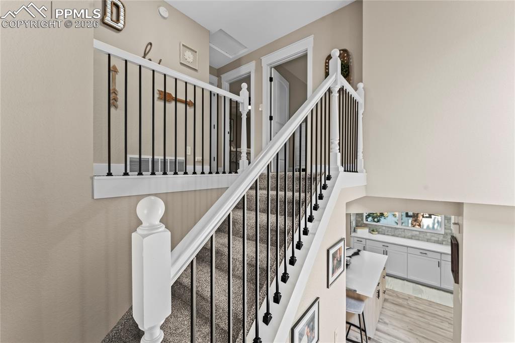 Image 17 of 44: Stairway featuring wood finished floors