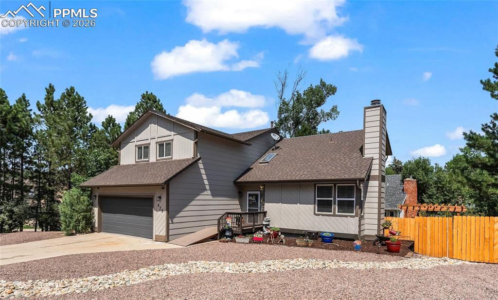 Image 2 of 44: View of front of home featuring roof with shingles, concrete driveway, a ch