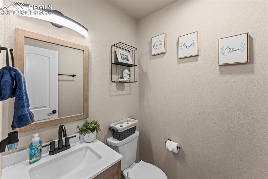 Image 20 of 44: Bathroom with vanity and a textured wall