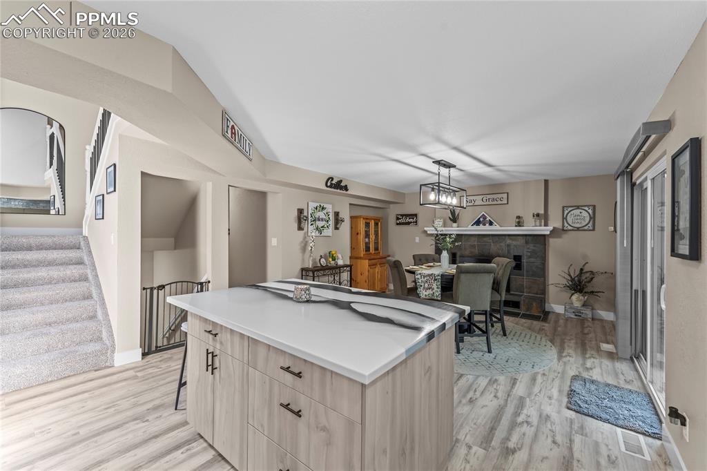 Image 3 of 44: Kitchen with light brown cabinetry, a kitchen island, modern cabinets, and
