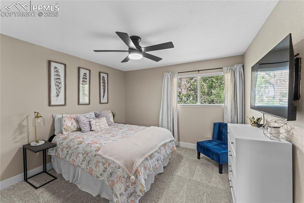 Image 30 of 44: Bedroom featuring light colored carpet and ceiling fan