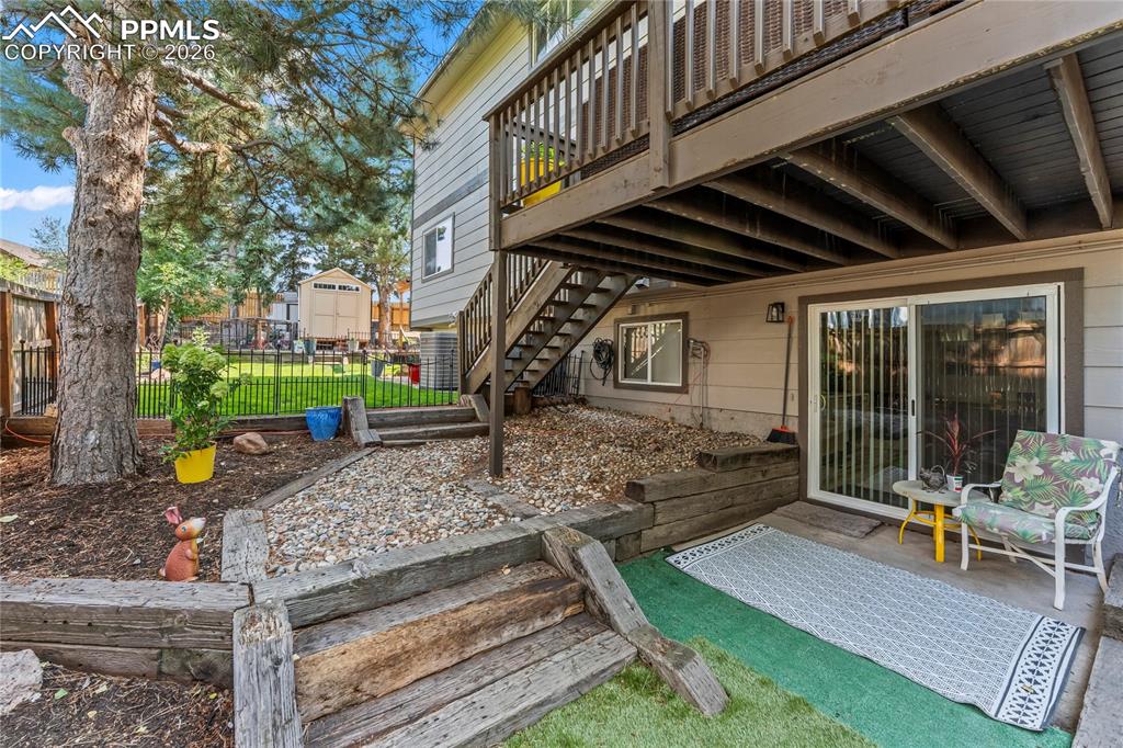 Image 37 of 44: View of patio / terrace featuring stairway and a deck