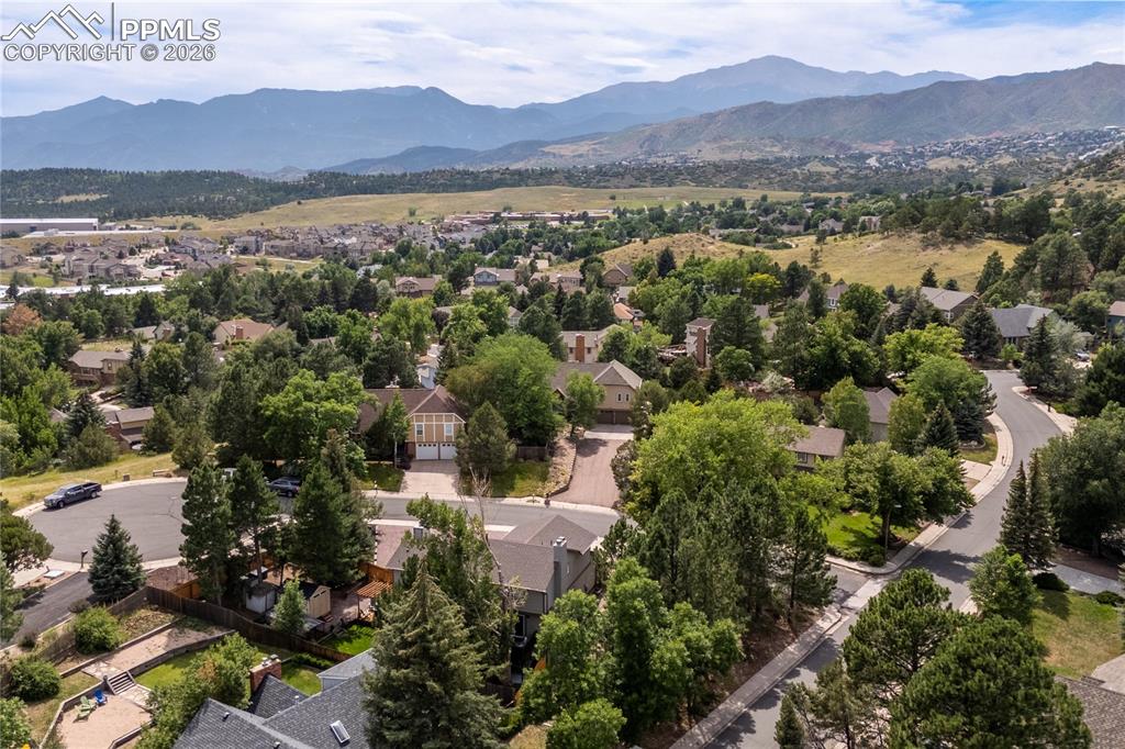 Image 44 of 44: Aerial view of residential area with a mountainous background