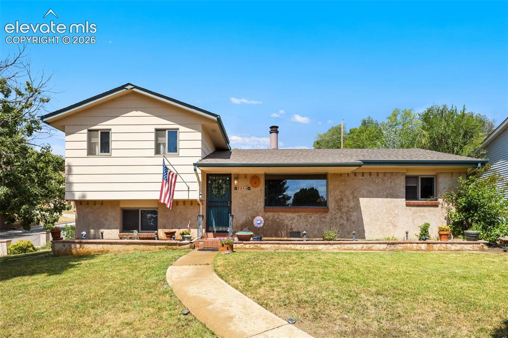 Caption: Front of home with mature landscaping on corner lot