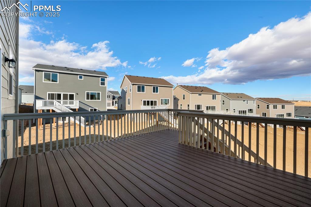 Image 2 of 38: Wooden terrace with a residential view