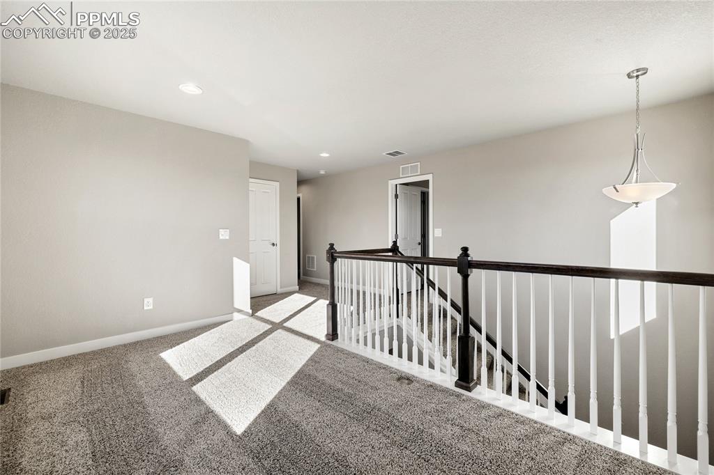Image 22 of 38: Unfurnished room with carpet floors and recessed lighting