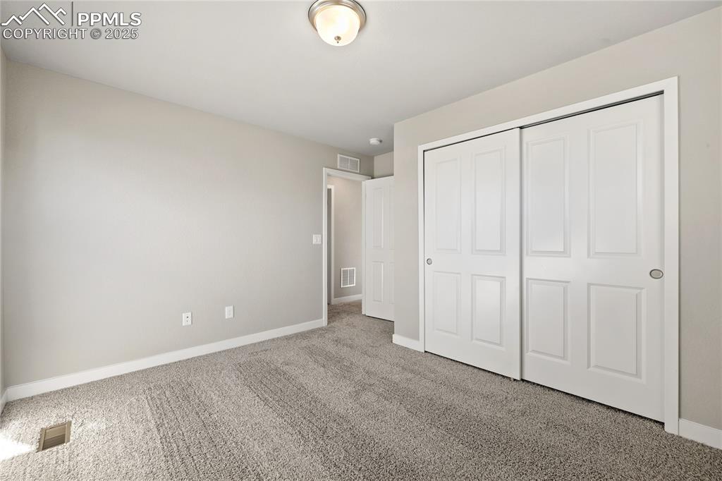 Image 26 of 38: Unfurnished bedroom with carpet floors and a closet