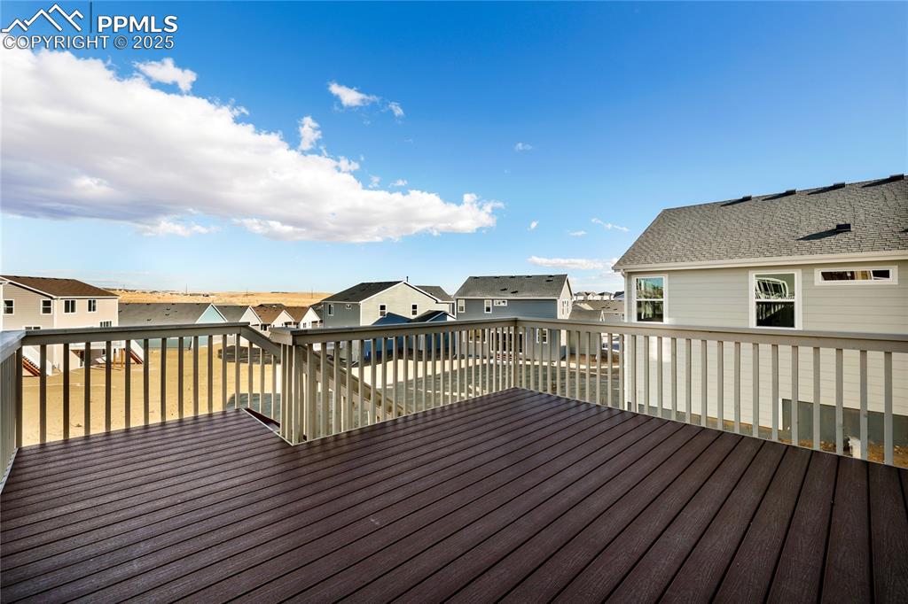 Image 3 of 38: Wooden terrace with a residential view