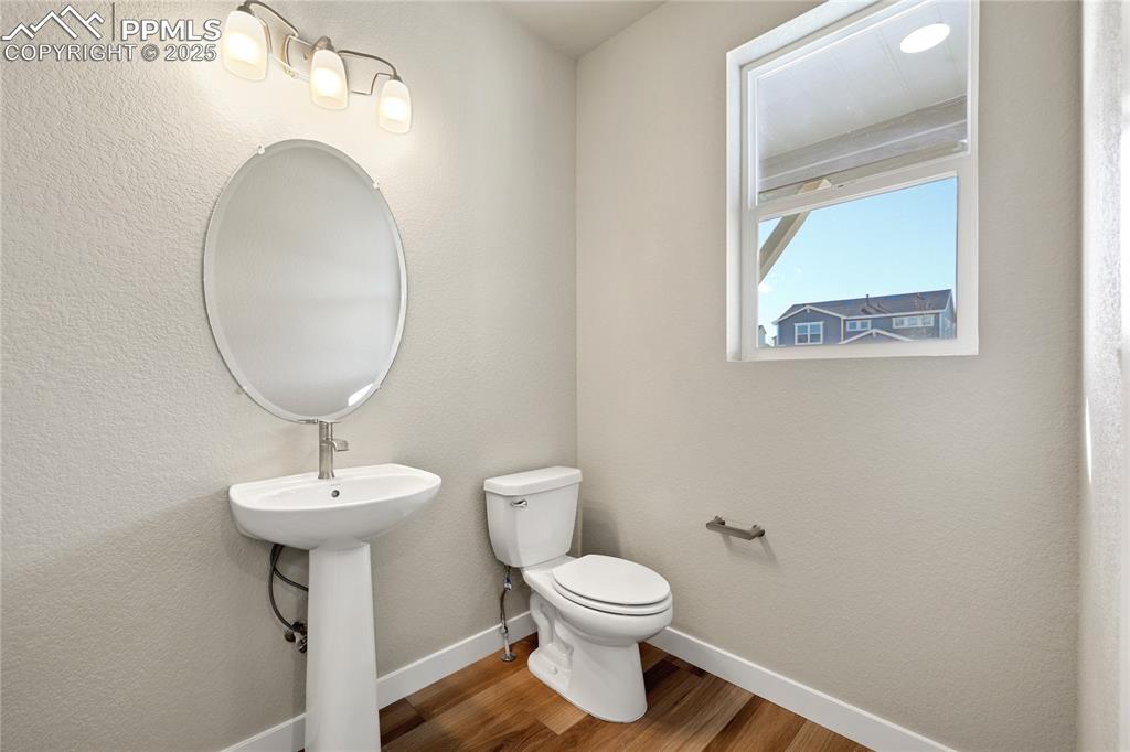 Image 8 of 38: Bathroom featuring a textured wall and wood finished floors