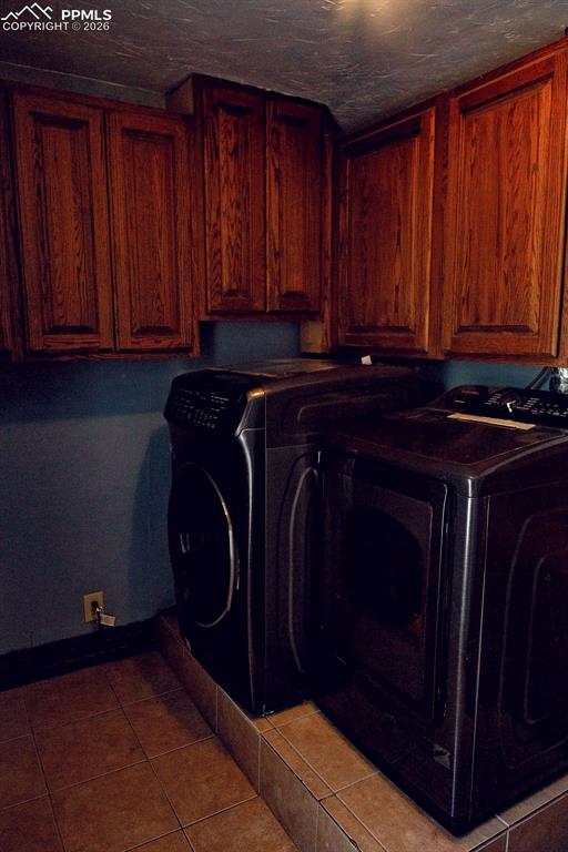 Image 35 of 38: Upper Level Laundry Room with Cabinets