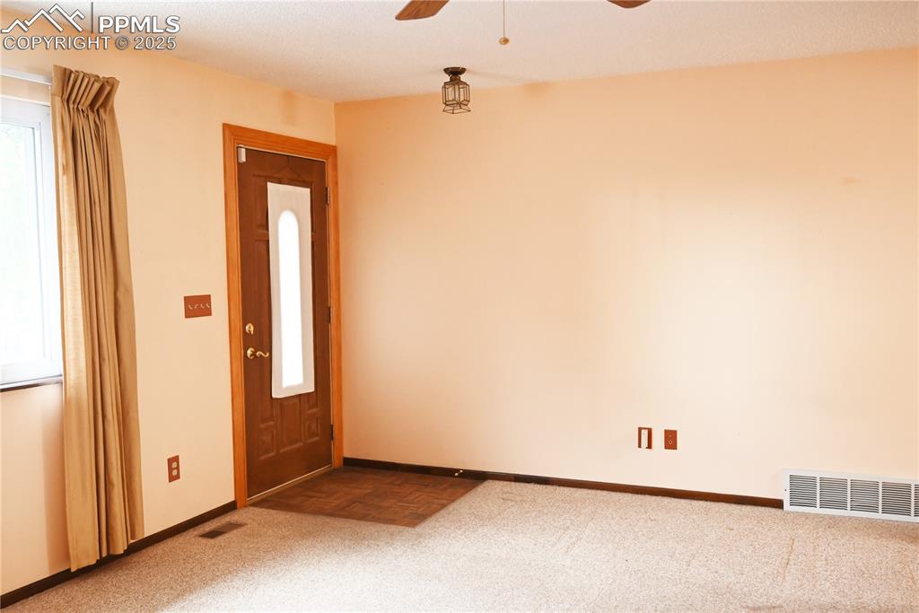 Image 11 of 17: Carpeted entryway with ceiling fan and baseboards