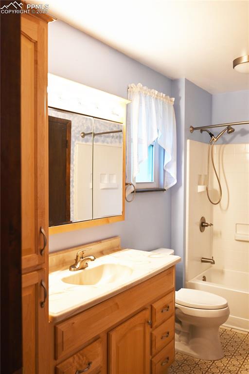 Image 6 of 17: Full bath with vanity and bathing tub / shower combination