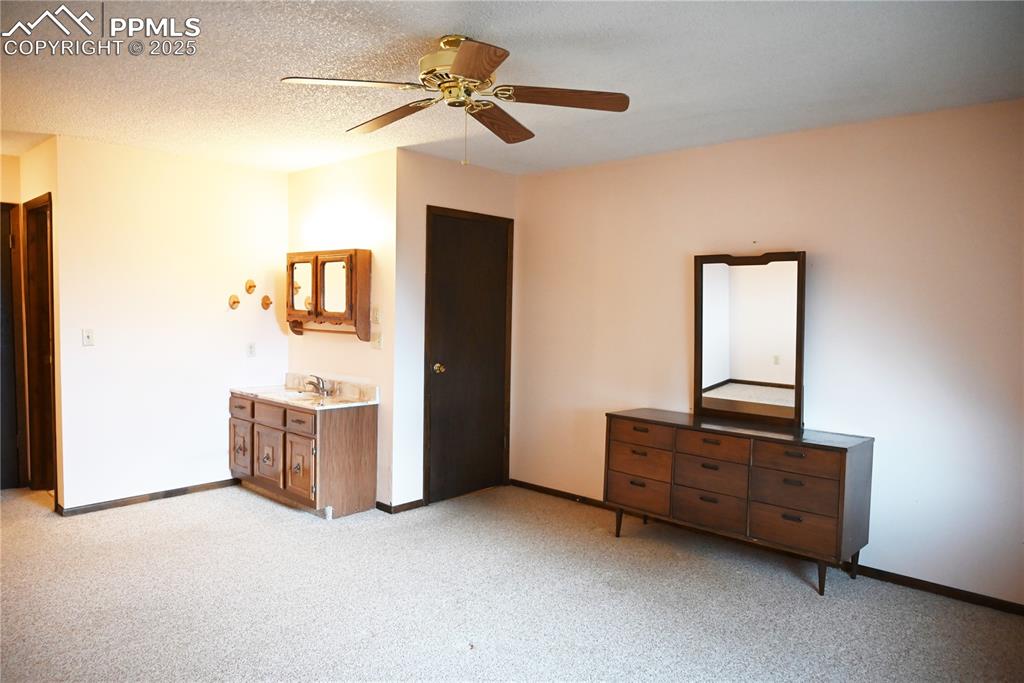Image 7 of 17: Unfurnished bedroom featuring light carpet and ceiling fan
