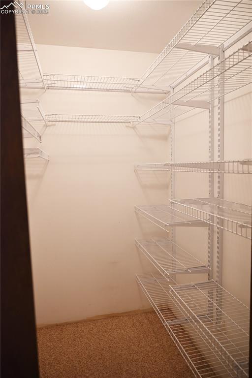 Image 9 of 17: Walk in closet featuring carpet