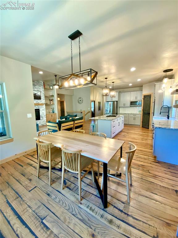Image 11 of 47: Dining room featuring wood flooring, multiple windows for natural light and