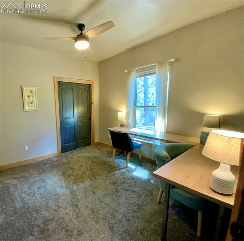 Image 20 of 47: Office/ bedroom area featuring carpet floors and a ceiling fan