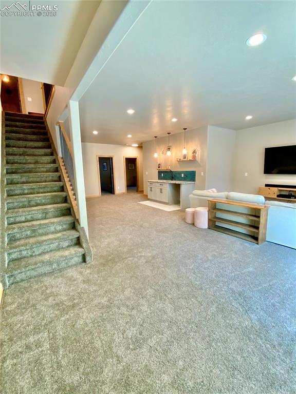 Image 25 of 47: Basement living space with wet bar