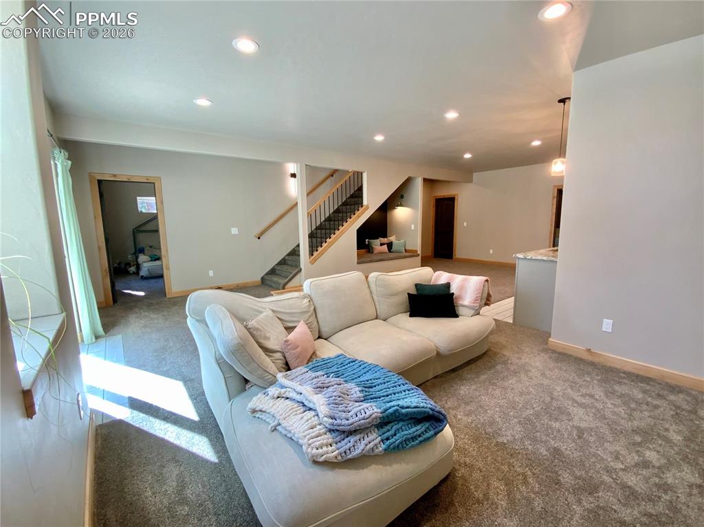Image 26 of 47: Carpeted basement living room with walkout and recessed lighting