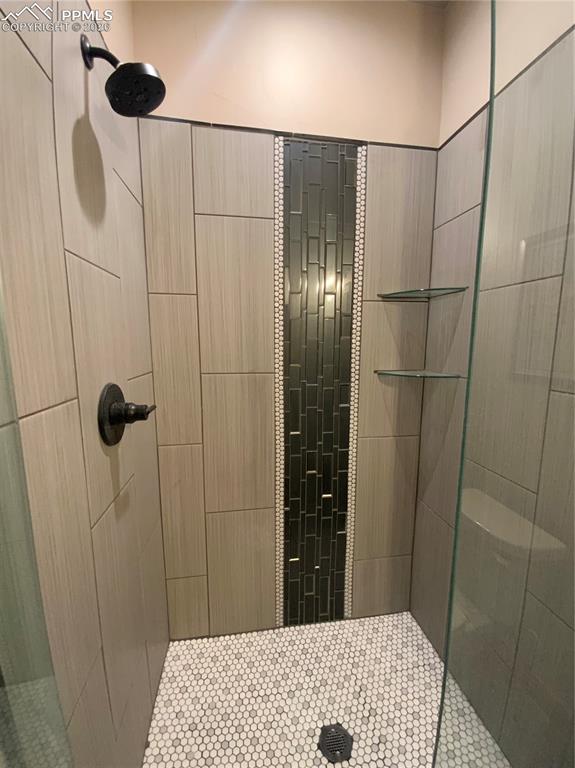 Image 32 of 47: Tile shower in en-suite bathroom