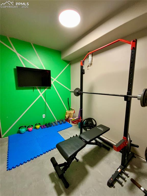 Image 38 of 47: Exercise room featuring concrete floors