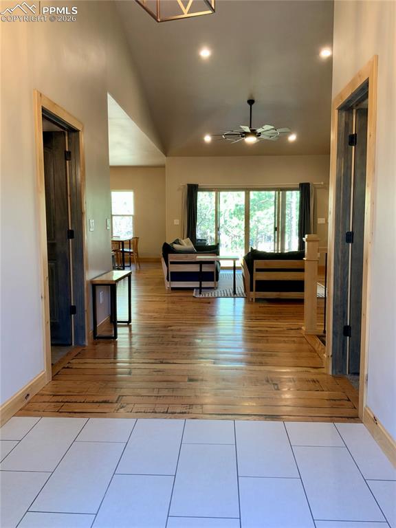 Image 4 of 47: Main entry featuring vaulted ceiling, tile floor transitioning to wood floo