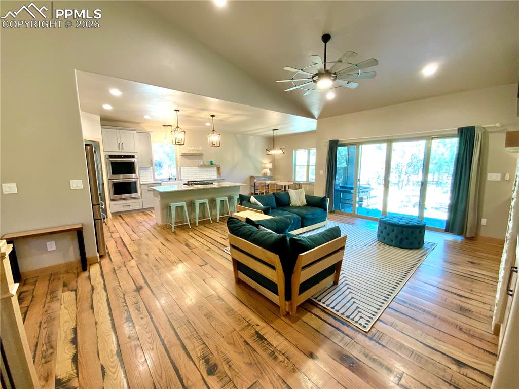 Image 7 of 47: Living area featuring recessed lighting, vaulted ceiling, a ceiling fan, an