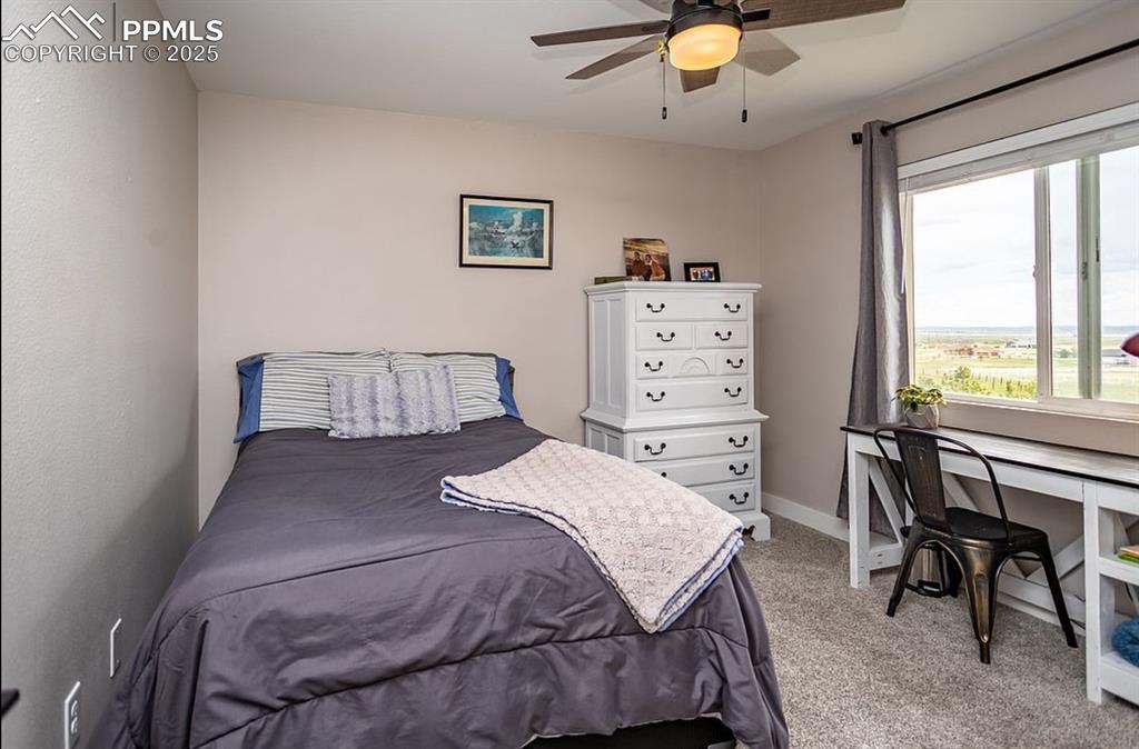 Image 22 of 44: Bedroom featuring a ceiling fan and light colored carpet
