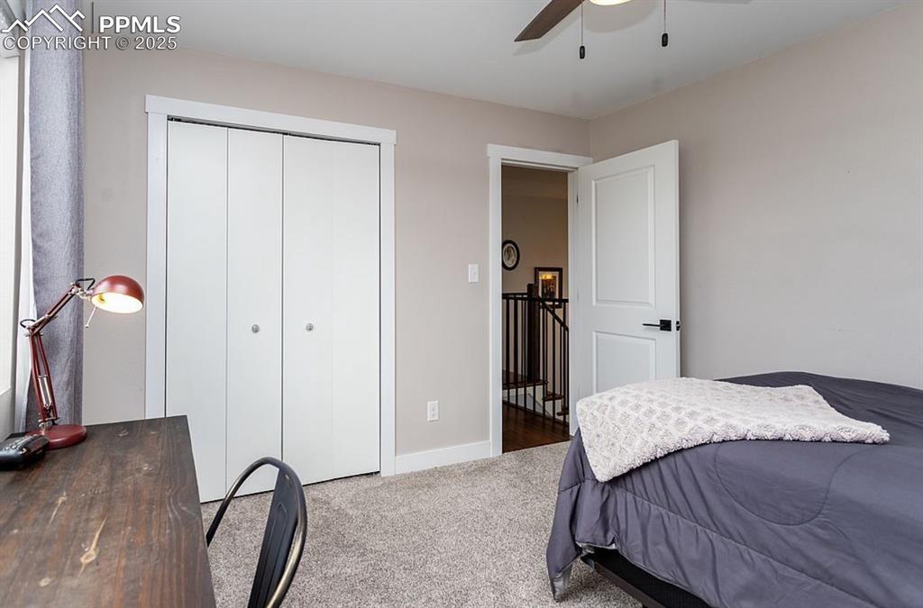 Image 23 of 44: Carpeted bedroom with a ceiling fan and a closet