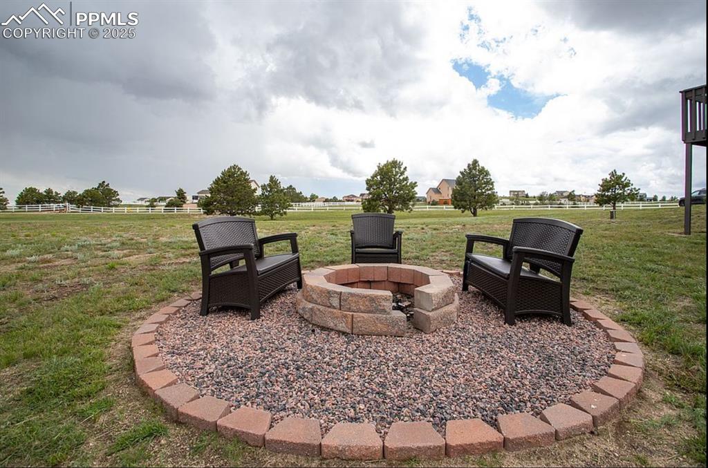 Image 33 of 44: View of patio featuring a fire pit