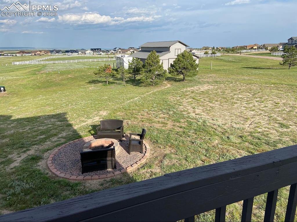 Image 34 of 44: View of yard with an outdoor fire pit, a shed, and a patio